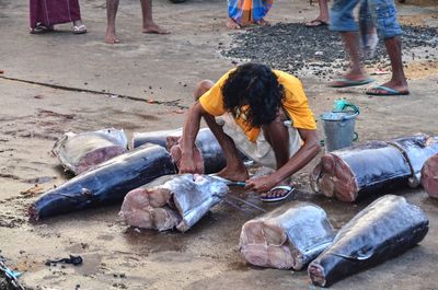 Man cutting fish at market