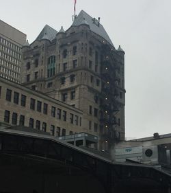 Low angle view of buildings against sky in city