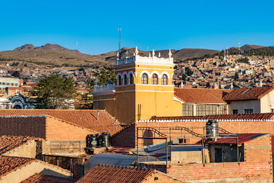 High angle view of houses in town against sky