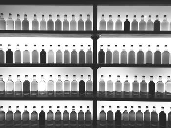 Full frame shot of alcohol bottles arranged on shelves