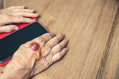 High angle view of person hand on table