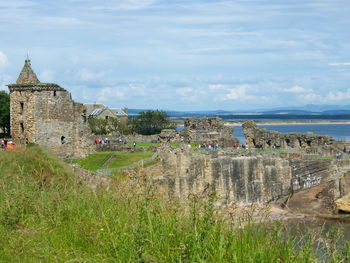 Historic building by sea against sky