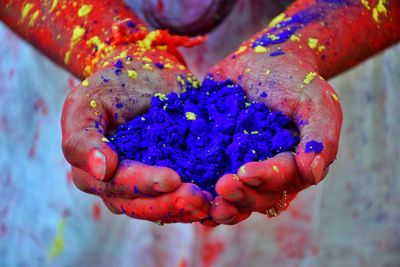 Close-up of woman holding multi colored hand