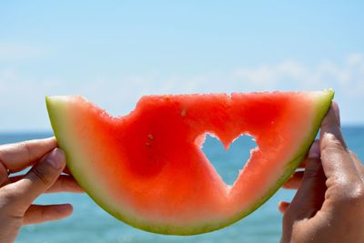 Cropped image of person holding watermelon 