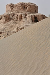 Sand dunes in desert against sky