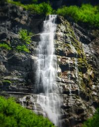Low angle view of waterfall against sky