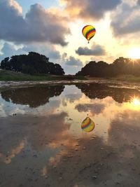 Reflection of clouds in sea at sunset