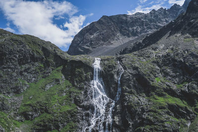 Low angle view of waterfall against sky