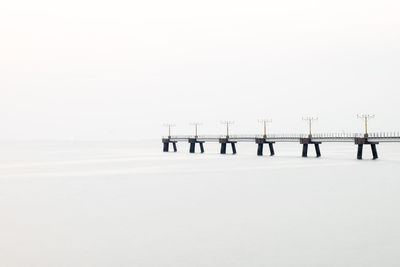 Scenic view of snow covered sea against clear sky