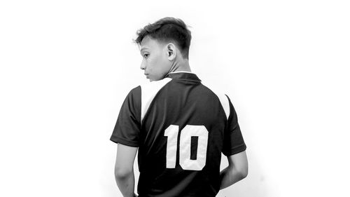 Man looking away standing against white background