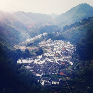 High angle view of houses and mountains against sky