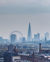 London eye and shard in city against sky