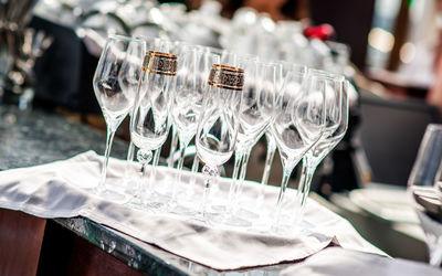 Close-up of empty wineglasses in plate at wedding