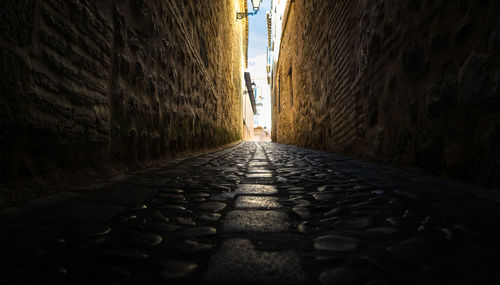 Surface level of narrow alley amidst buildings