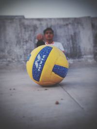 Portrait of man with ball in background