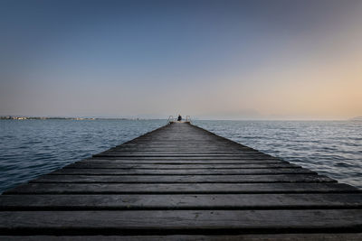 Pier over sea against clear sky