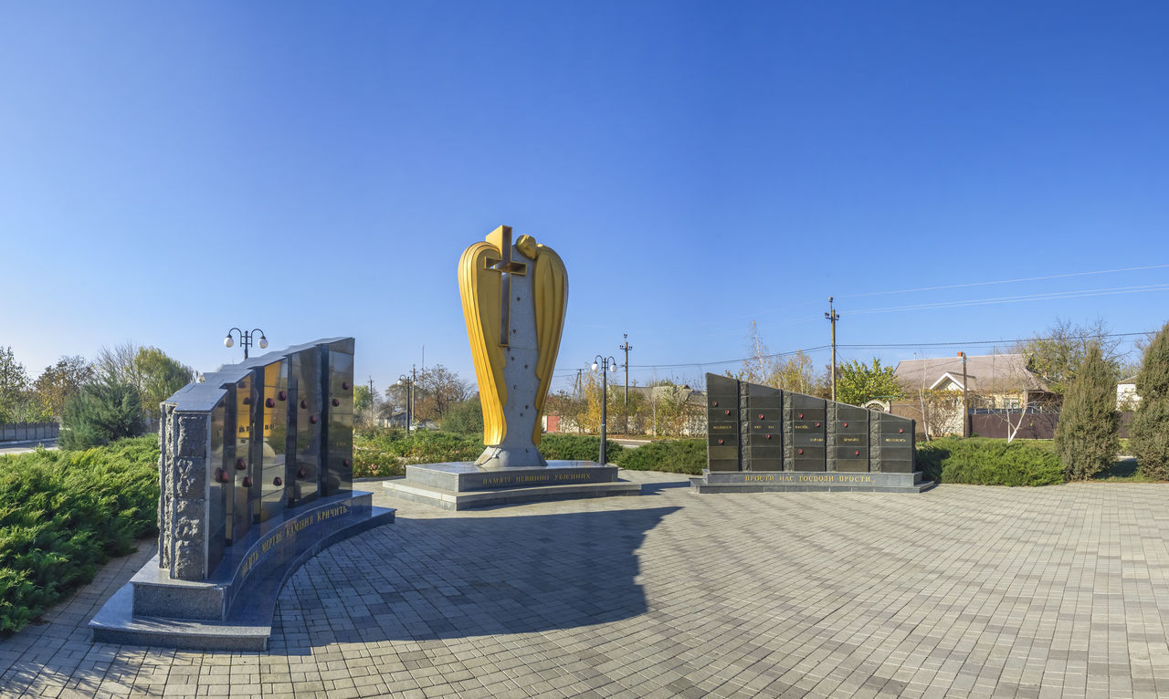 STATUE AGAINST CLEAR BLUE SKY