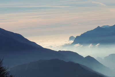 Scenic view of snowcapped mountains against sky during sunset