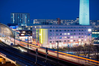 Light trails on railroad station in city at night