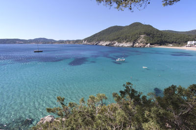 View of calm blue sea against mountain range