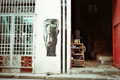 Statue against window of building