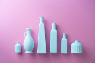 Close-up of wine bottles against colored background