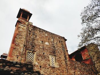 Low angle view of old building against sky