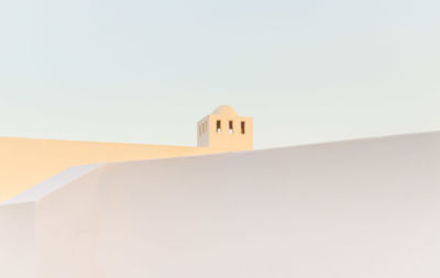 Low angle view of whitewashed building against clear sky