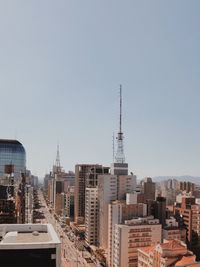 Buildings in city against clear sky