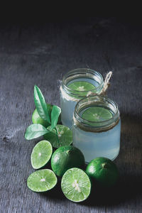 Fresh limeade on dark wooden table, top view with copy space, life style