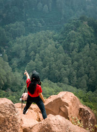 Rear view of man walking on mountain