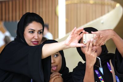 Portrait of woman holding mobile phone