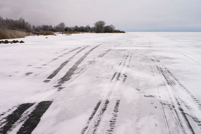 Snow covered field against sky