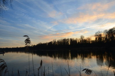 Scenic view of lake against sky during sunset