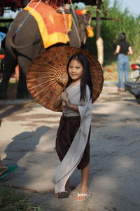 Portrait of smiling girl on footpath