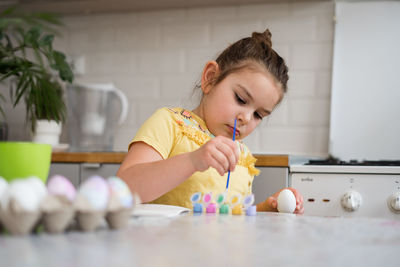 Boy playing with toy blocks at home