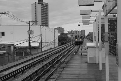 Train on railroad tracks by station in city