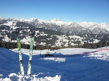 Scenic view of snow covered mountains against clear sky