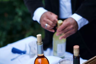 Close-up of man holding glass bottle