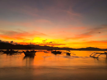 Scenic view of lake against romantic sky at sunset