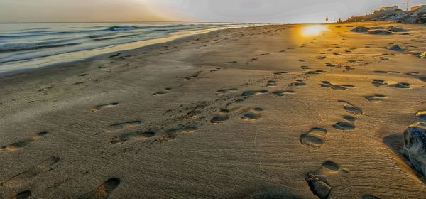Footprints on sand at beach