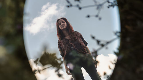 Low angle view of woman on tree