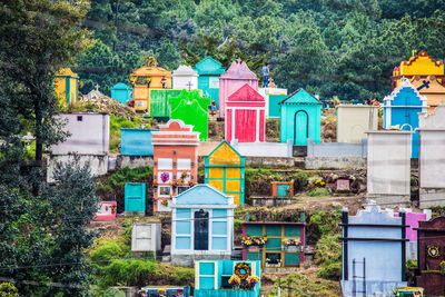 Multi colored houses against buildings in city