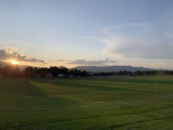 Scenic view of field against sky during sunset