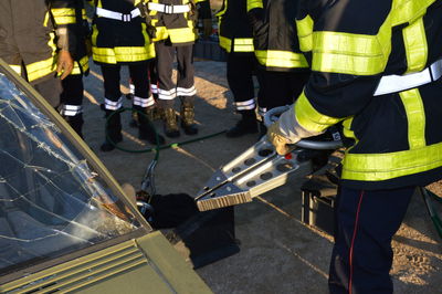 Firefighters against broken car in city