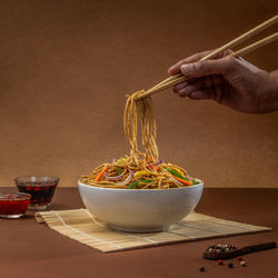 Cropped hand of person preparing food on table