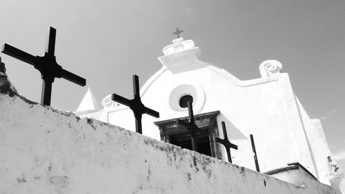 Low angle view of cross against clear sky