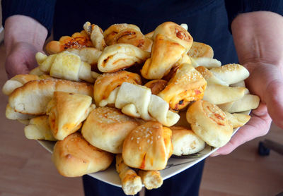 Midsection of person carrying fresh snacks in tray