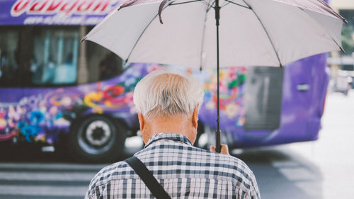 Rear view of man with umbrella