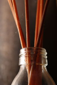 Close-up of incenses in glass bottle